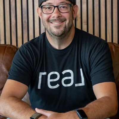 Kevin Evers, Wisconsin State Broker, Real Broker LLC logo